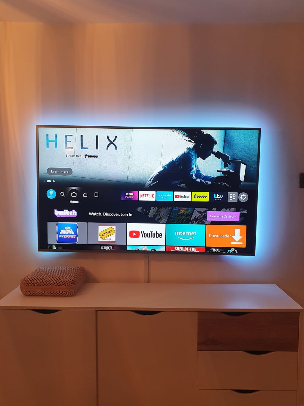 TV with LED backlighting on white cabinet
